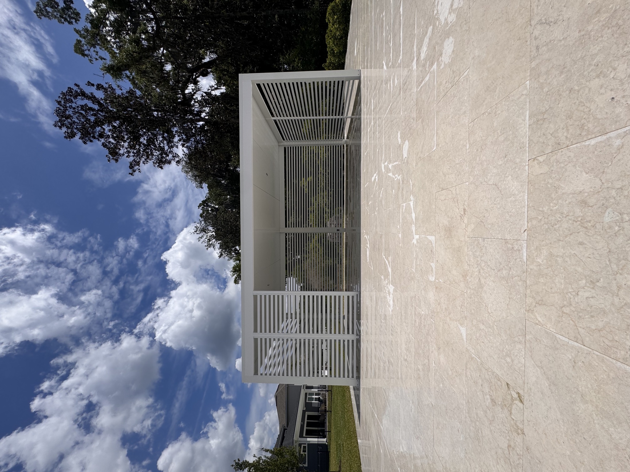 Completed white aluminum poolside cabana with privacy slats