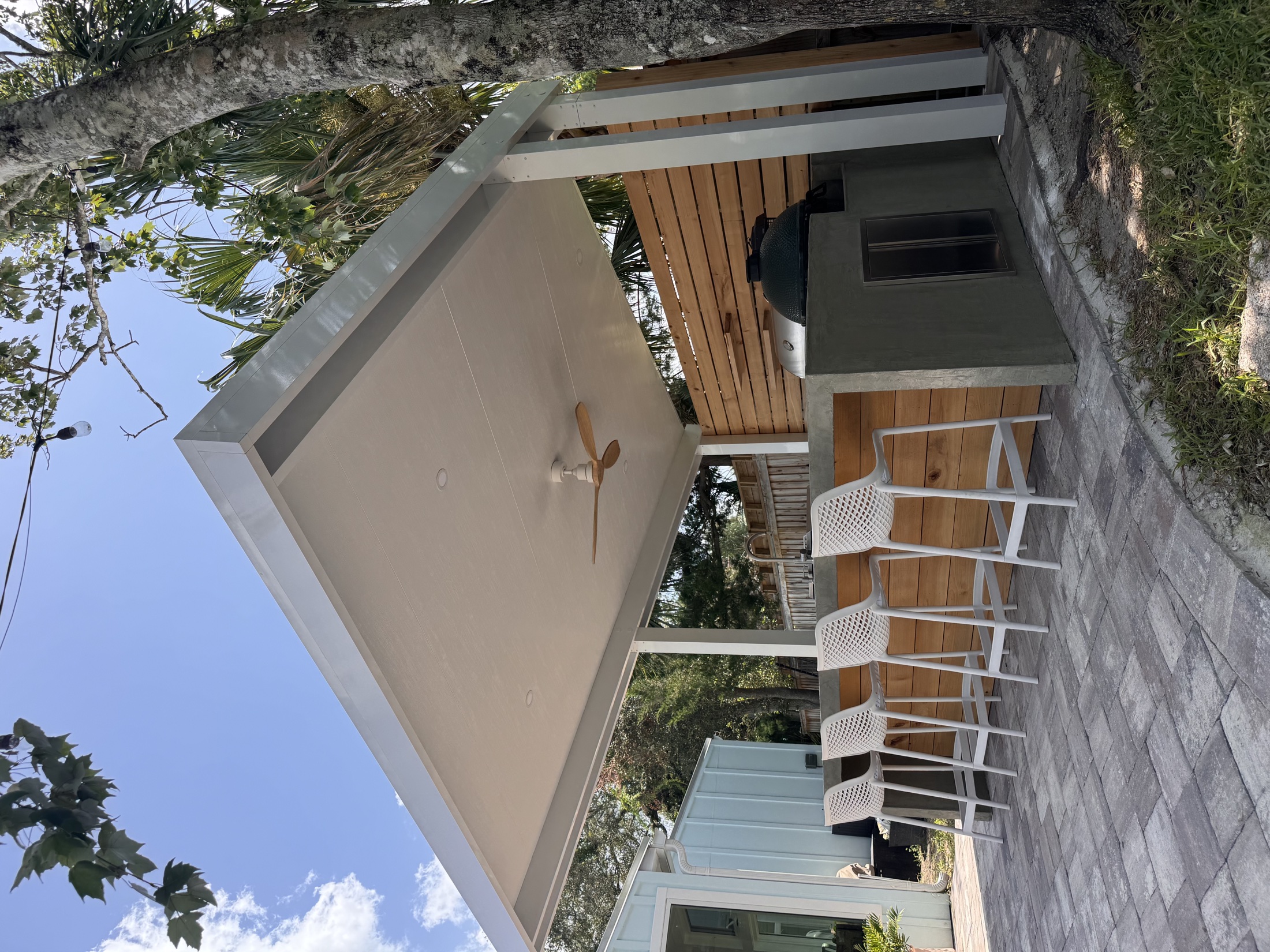 Completed insulated patio cover above an outdoor bar and grill